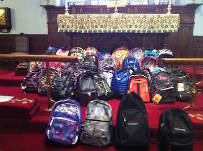 backpacks laying in front of church altar